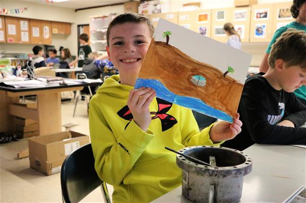 J.J. displays his beach painting 